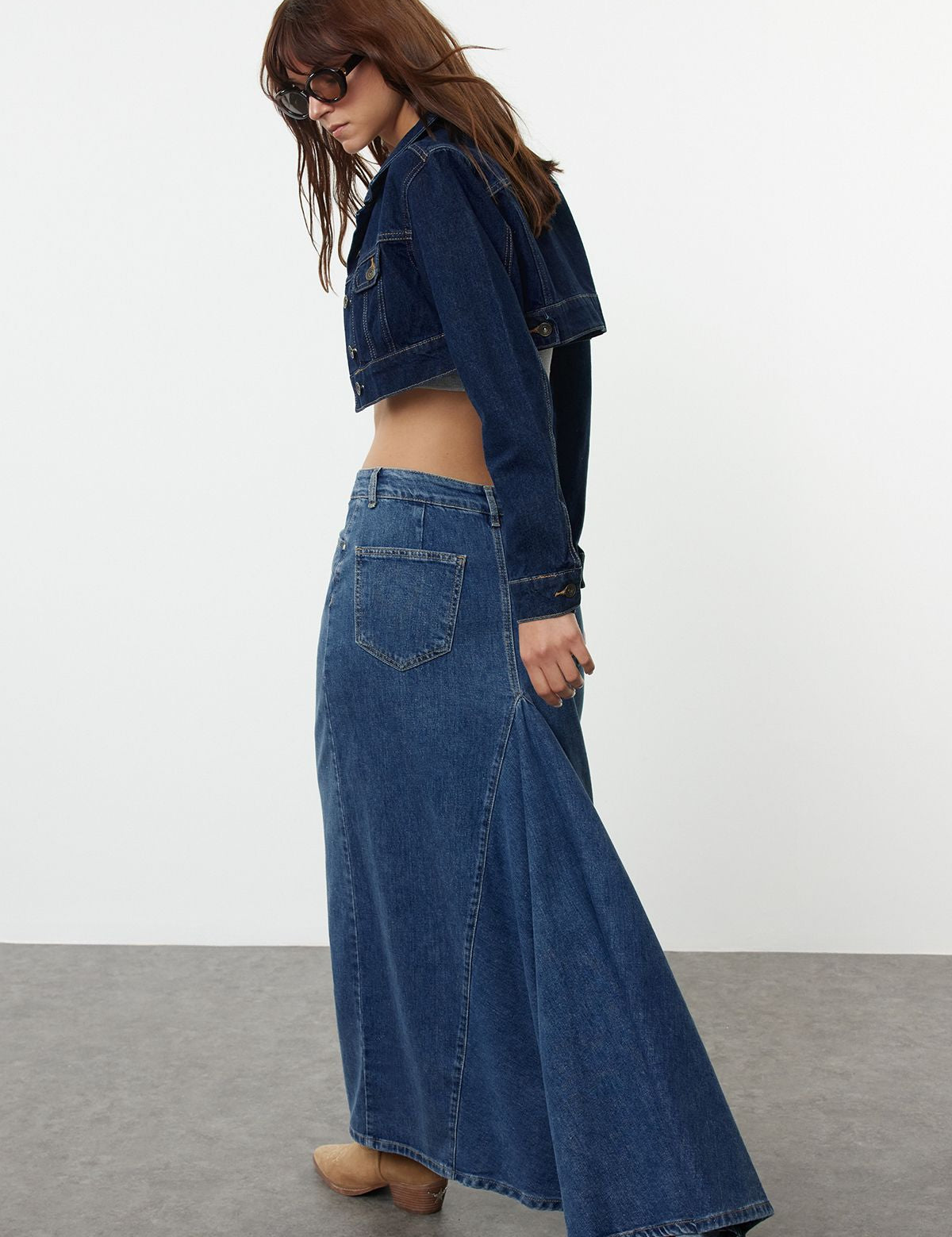 Elevate your wardrobe with this classic high-waisted denim maxi skirt featuring a flared fit. Perfect for versatile styling, this medium wash skirt is ideal for any casual outing. Shop now!