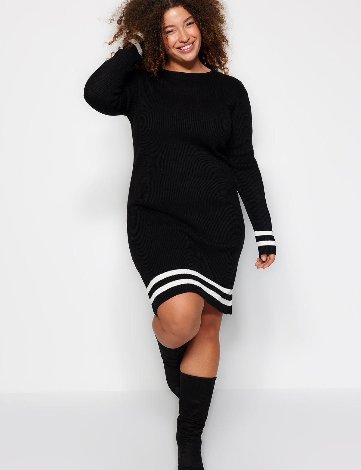 Discover the ultimate fall staple with this black knit sweater dress featuring chic striped accents. Perfect for casual outings or cozy nights, this versatile dress pairs effortlessly with boots or tights.