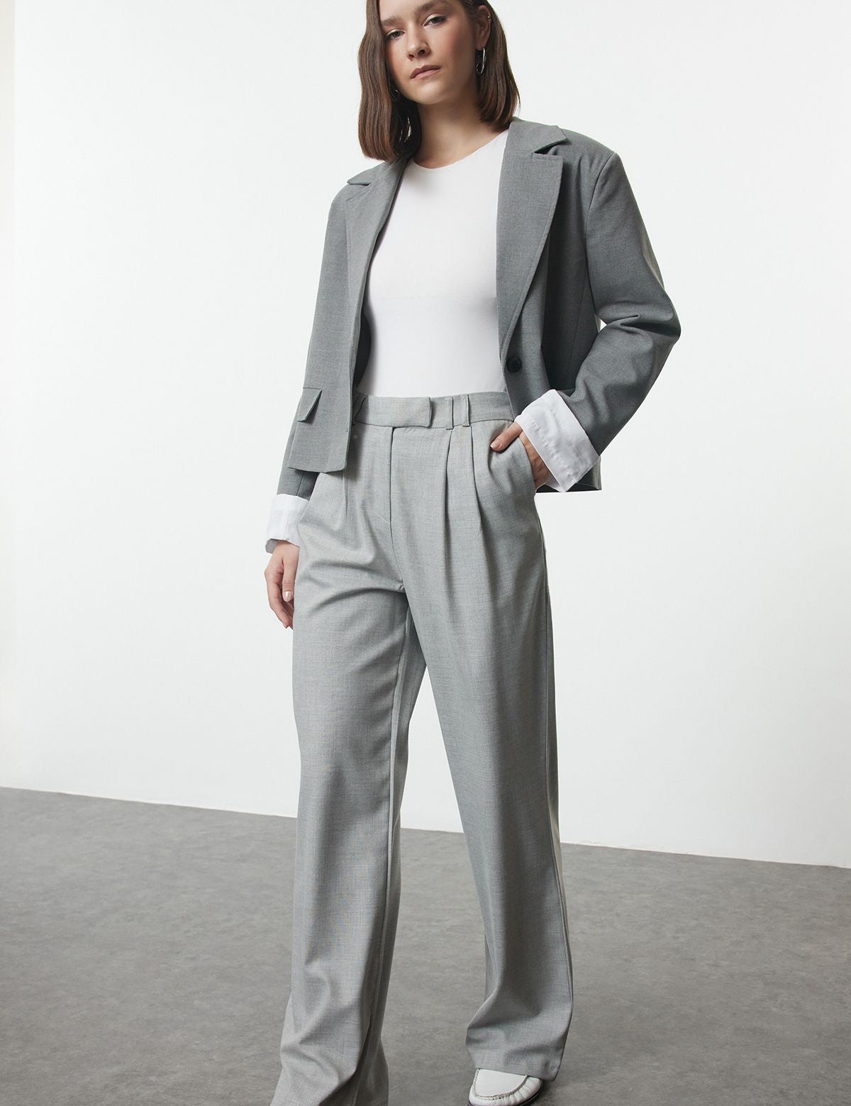 Step up your style game with our Women’s Light Grey Wide-Leg Trousers. These minimalist, high-waisted pants offer a flattering fit and versatile design, perfect for both office and casual wear.