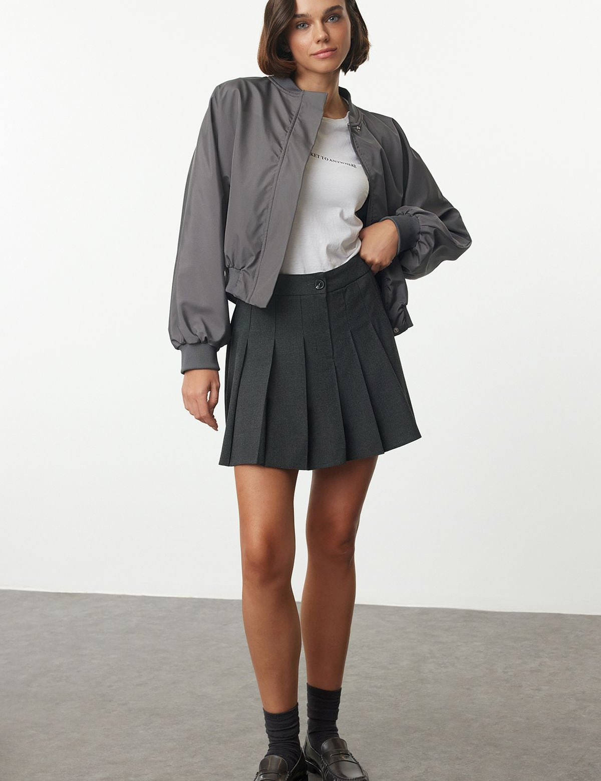 Shop our classic dark gray pleated mini skirt with a high-waist design. Perfect for a school uniform-inspired look, this versatile skirt is ideal for casual, office, or evening wear. Machine washable and easy to care for.