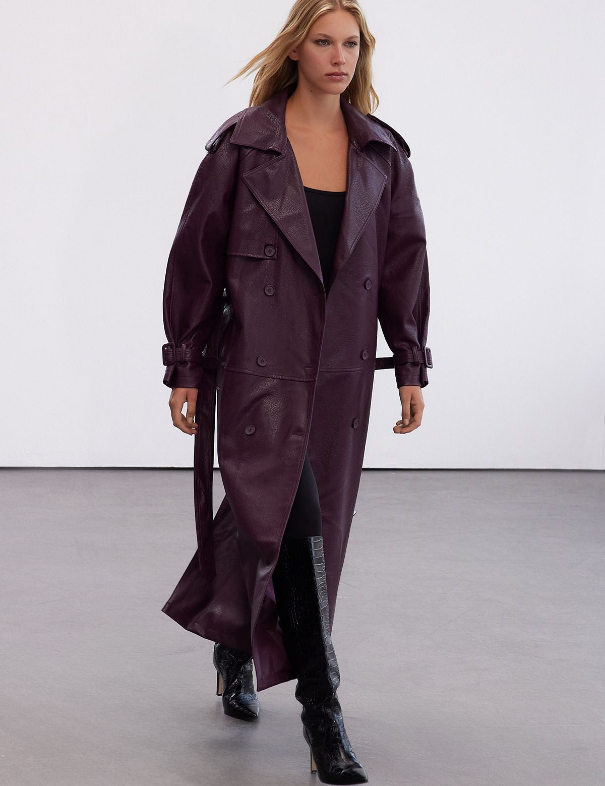 Step out in style with our Plum Faux Leather Trench Coat. This oversized longline jacket in a rich plum color is perfect for layering and making a bold statement. Shop now!
