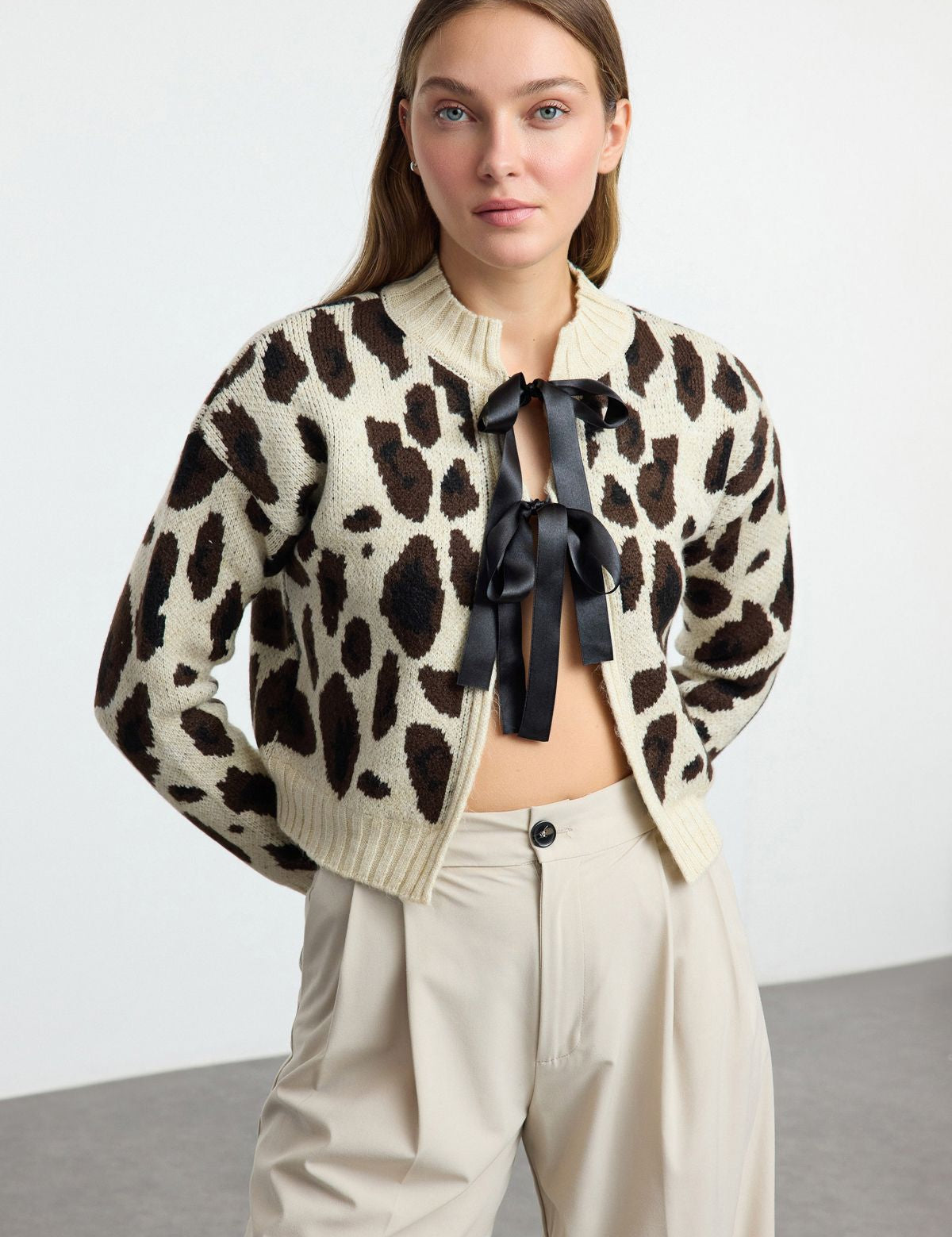 Leopard print cardigan with satin ribbon tie, paired with neutral trousers, perfect for versatile styling.”

Add to cart now for an effortless style upgrade!”

Knitwear, Animal Print, Fall Essentials, Statement Pieces.