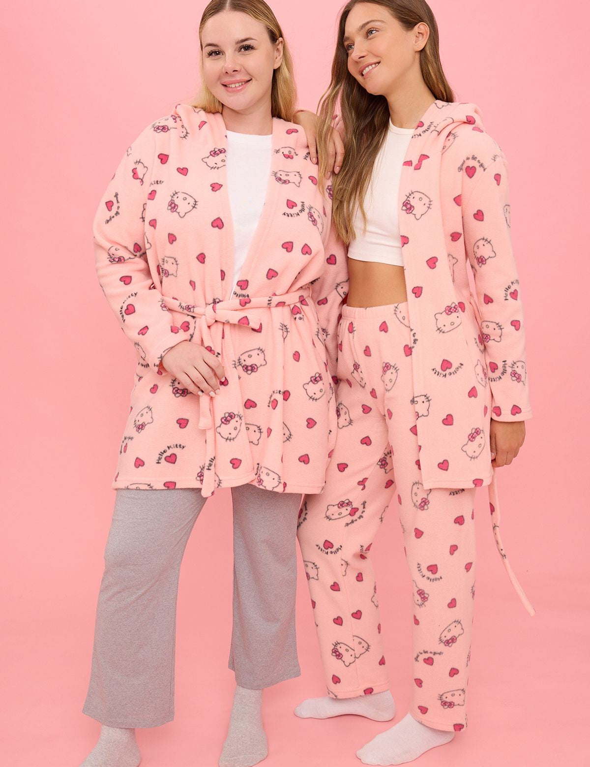 Stay cozy with our Hello Kitty fleece robe and matching pajama set. Featuring adorable heart prints, perfect for lounging or gifting. Shop now for ultimate comfort!