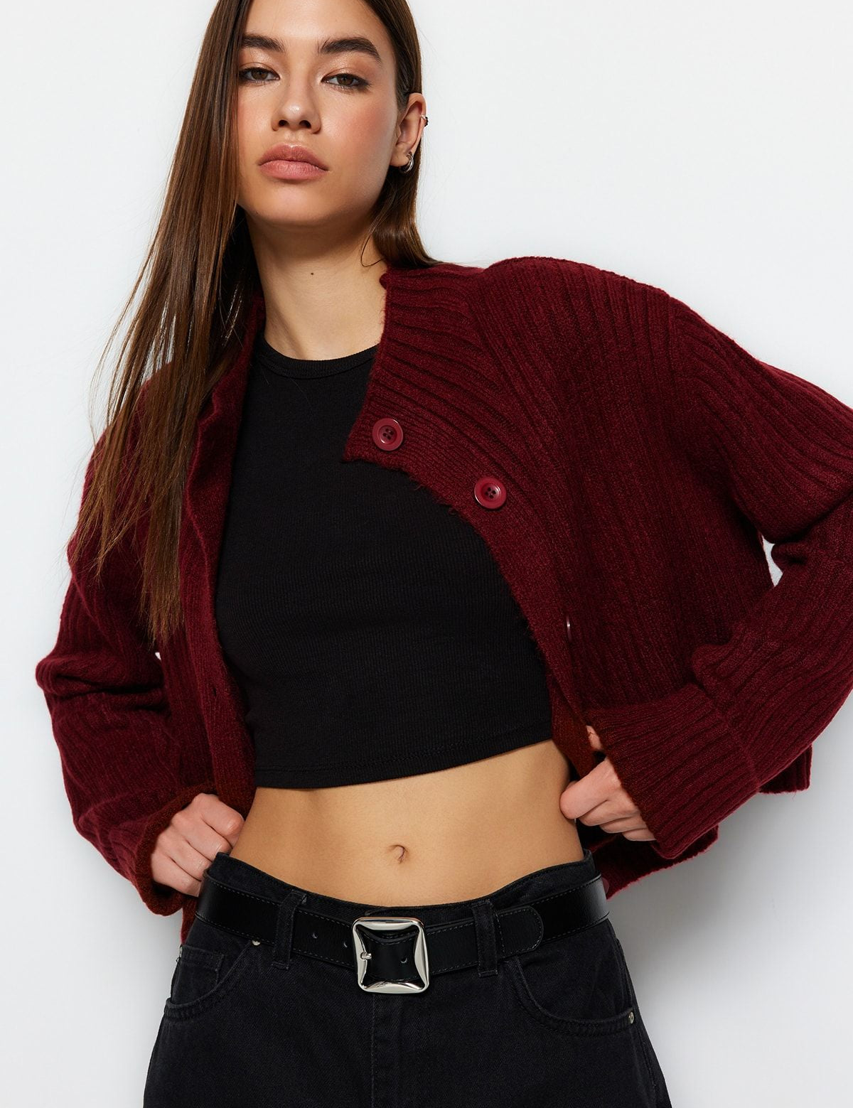 Stay warm in style with our Chunky Ribbed Button-Up Cardigan. Featuring a high neck and bold buttons, this burgundy knit sweater is perfect for layering. Shop now for a cozy classic!