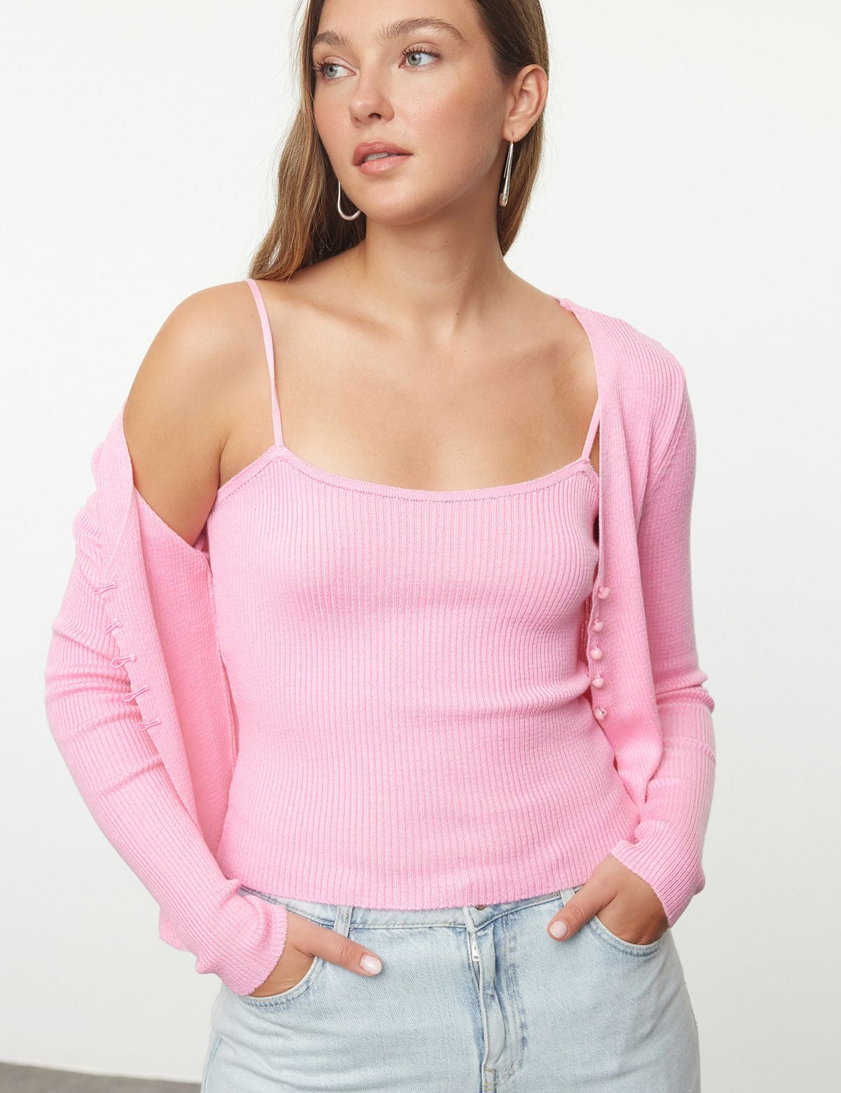 Brighten your wardrobe with our Pink Ribbed Knit Tank Top and Cardigan Set. This soft two-piece set offers versatile style for any occasion. Shop now for a chic and cozy look!
