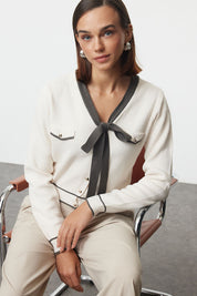 
Add a touch of elegance to your wardrobe with our Bow Tie Contrast Trim Cardigan. This stylish white and gray knit sweater features chic details and a flattering fit. Shop now for timeless style!