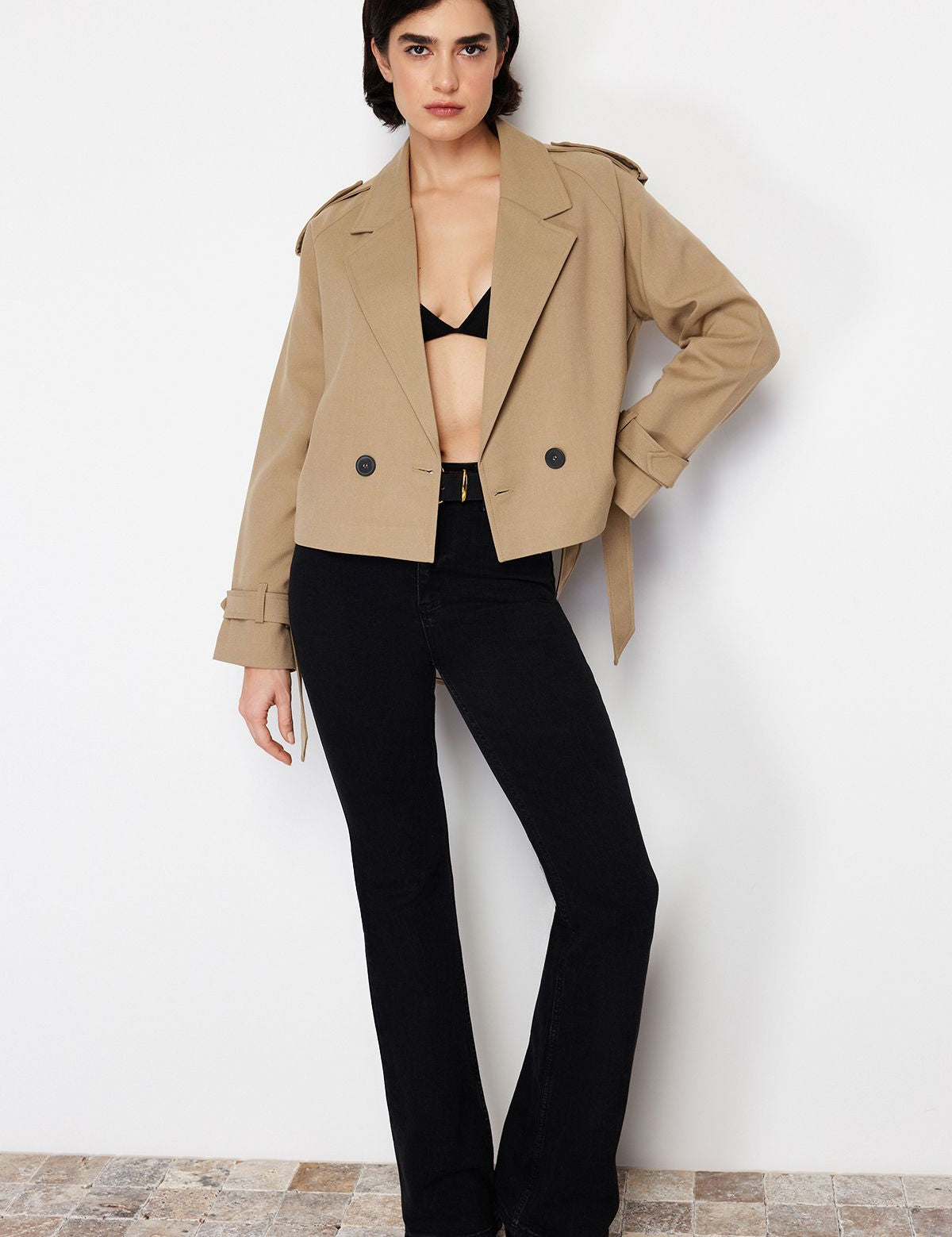 Elevate your wardrobe with our cropped belted camel trench jacket, designed for style and comfort. This lightweight outerwear features a tailored fit, flattering waist belt, and timeless design—perfect for any occasion. Shop now for the latest in women’s fashion outerwear.