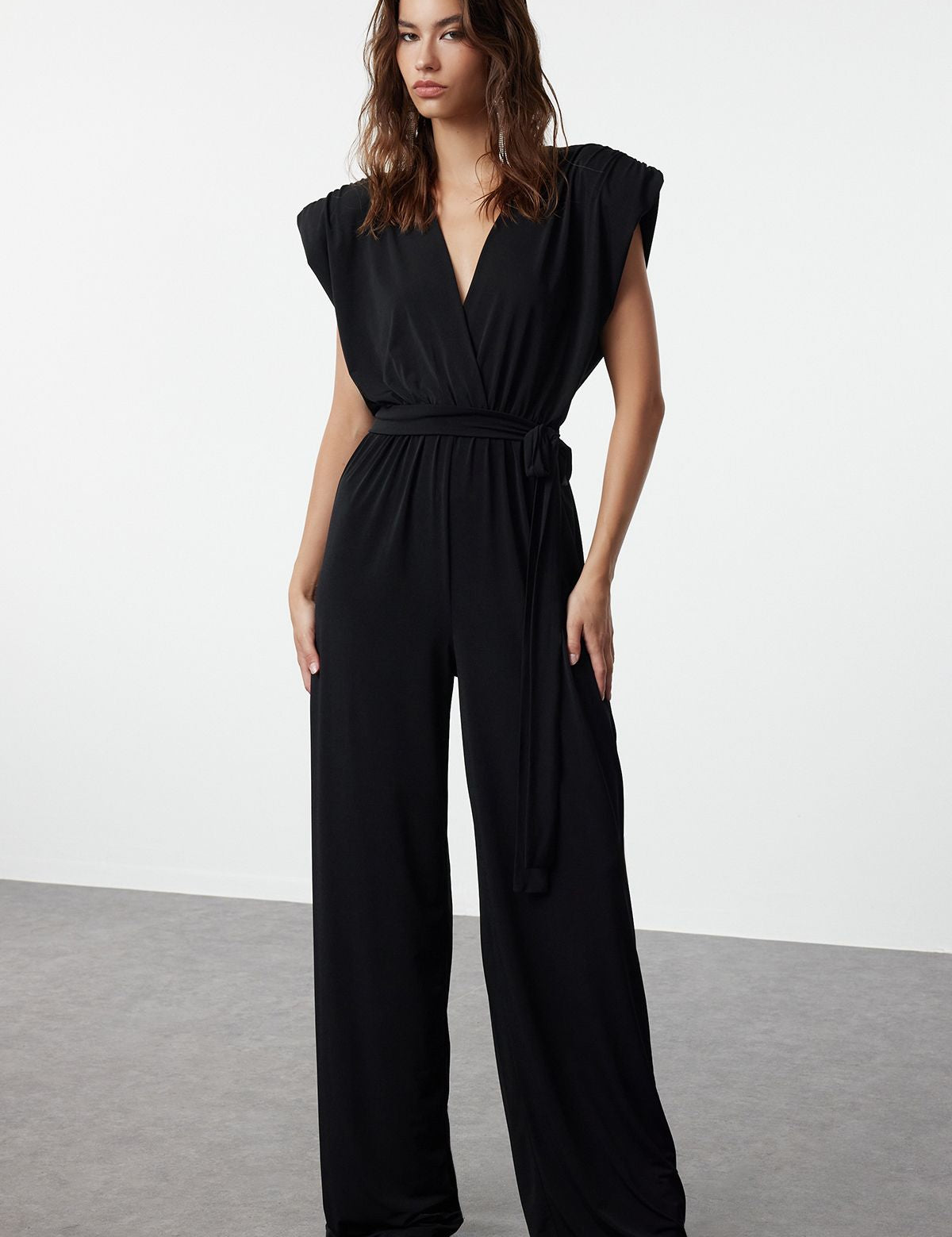 Shop this elegant black wide-leg jumpsuit with a belted waist. Perfect for formal events or chic evenings out. Sophisticated, modern, and effortlessly stylish!