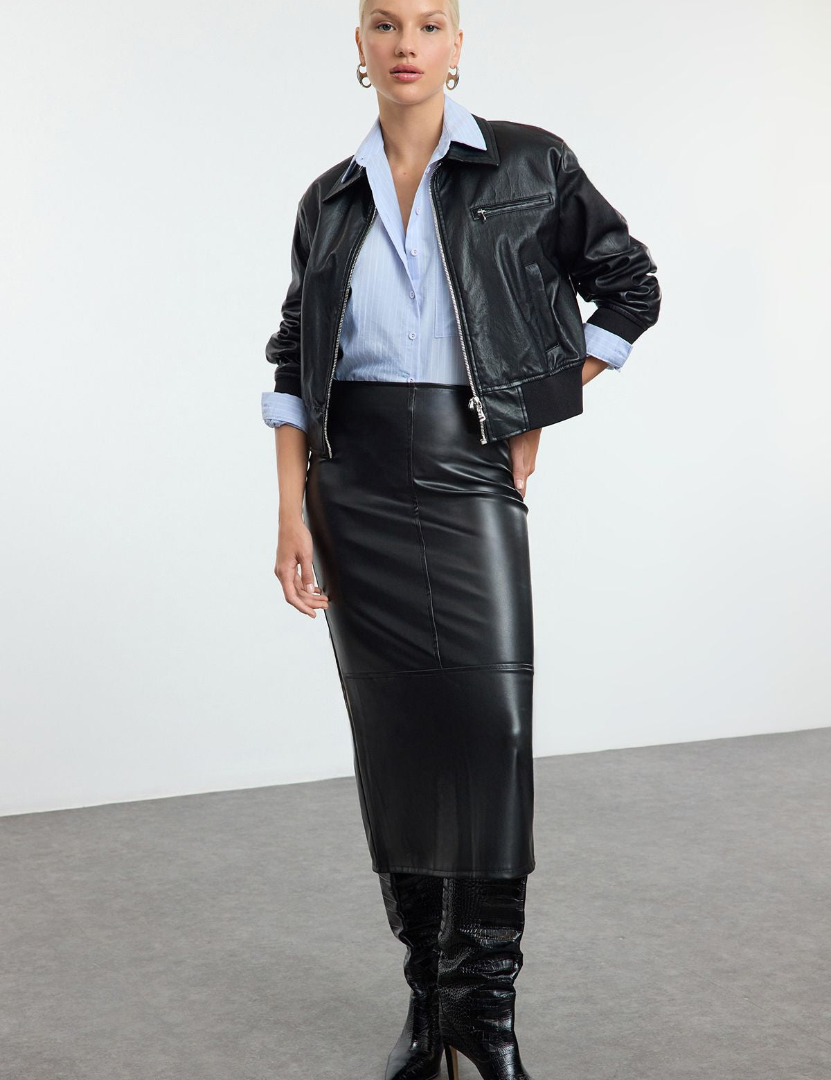 Shop our Faux Leather Midi Skirt for a sleek and versatile style. This high-waisted, midi-length skirt is perfect for day-to-night looks, offering a chic leather-like finish.