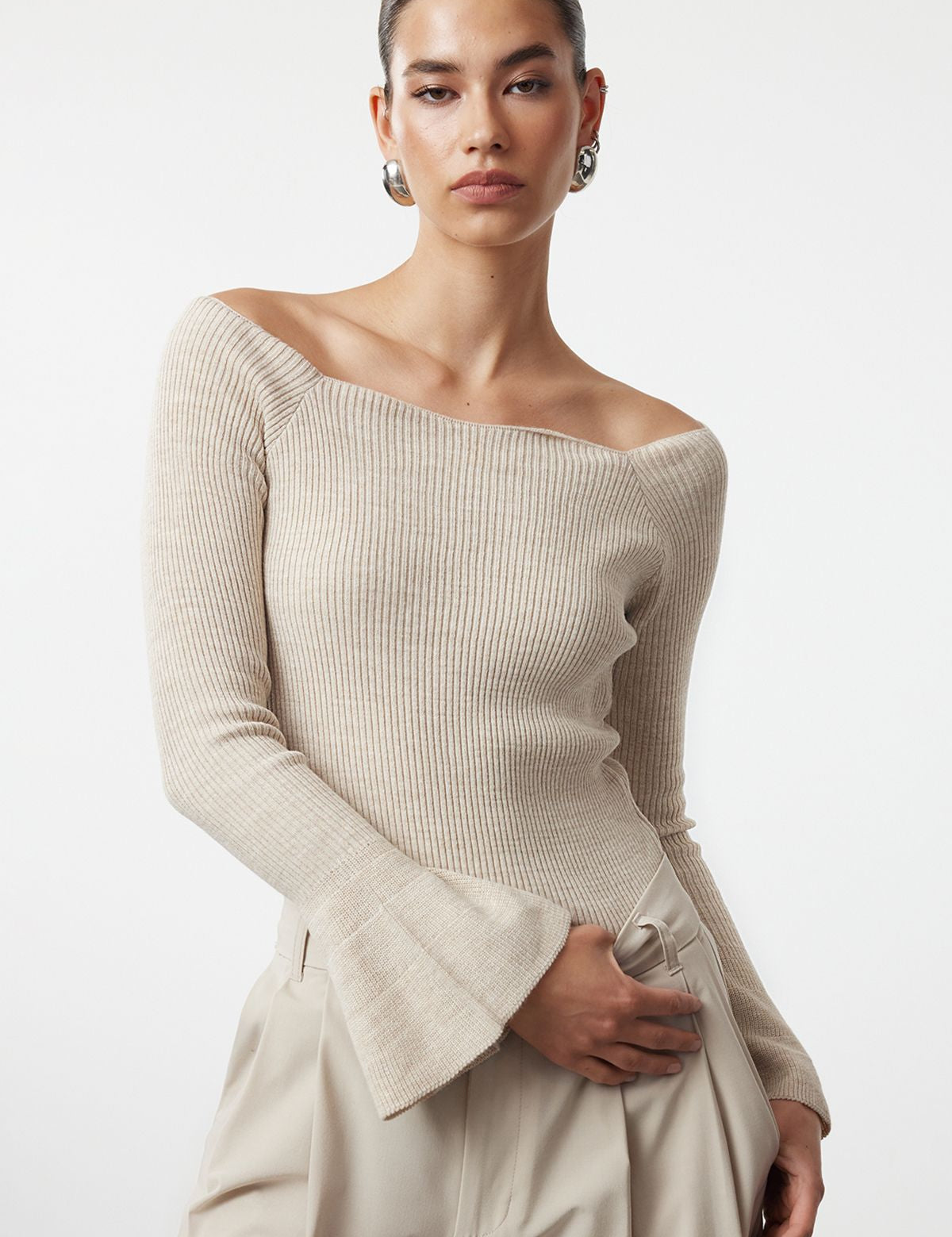 Shop our Off-Shoulder Ribbed Knit Sweater in beige, featuring stylish bell sleeves and a flattering off-the-shoulder neckline. Perfect for both casual and elegant looks. Discover timeless chic now!
