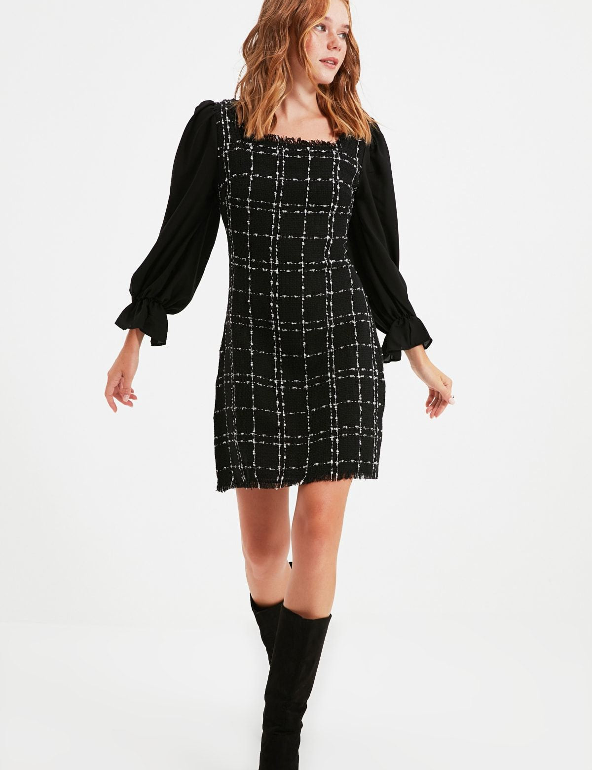 Shop the Chic Black Plaid Puff Sleeve Mini Dress for a blend of classic and contemporary styles. Perfect for day-to-night transitions, this dress is a wardrobe essential.