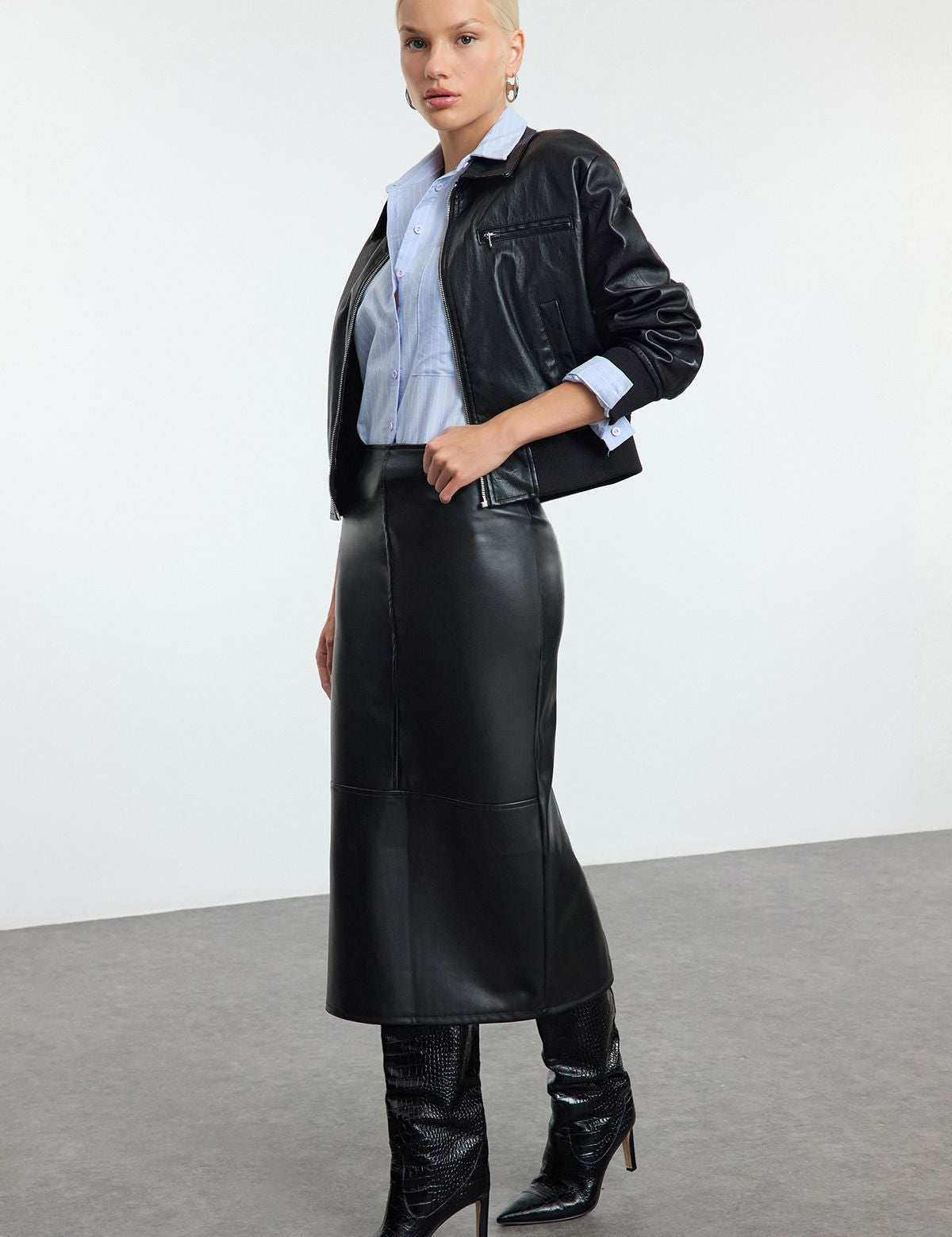 faux leather midi skirt, leather-look skirt, women’s faux leather clothing, high-waisted skirt, black midi skirt, sleek leather skirt, edgy leather style, versatile leather skirt, women’s statement skirts, fashion midi skirts