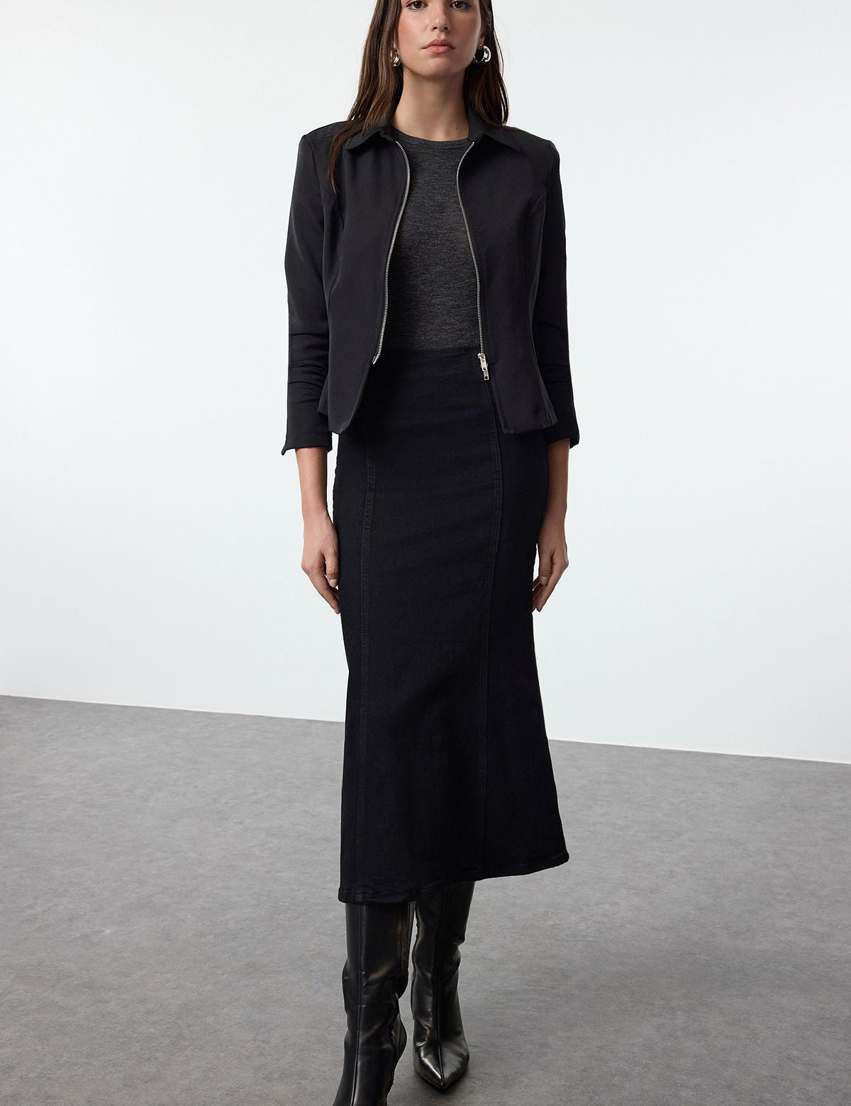 Discover timeless fashion with our high-waisted black denim midi skirt. Perfect for casual or formal wear, this soft denim skirt offers versatile styling options for every season.