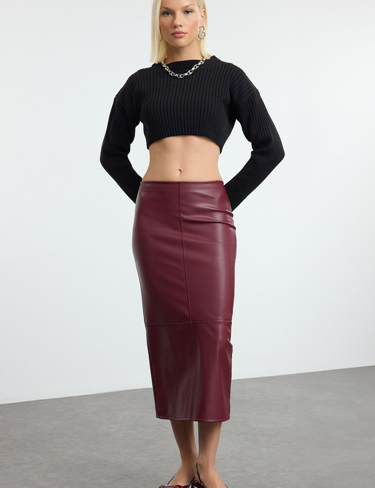 burgundy faux leather midi skirt, high-waisted leather skirt, sleek leather skirt, women’s faux leather fashion, elegant midi skirt, burgundy skirt outfit, statement leather skirt, versatile women’s skirt, chic midi skirts, women’s office and evening wear