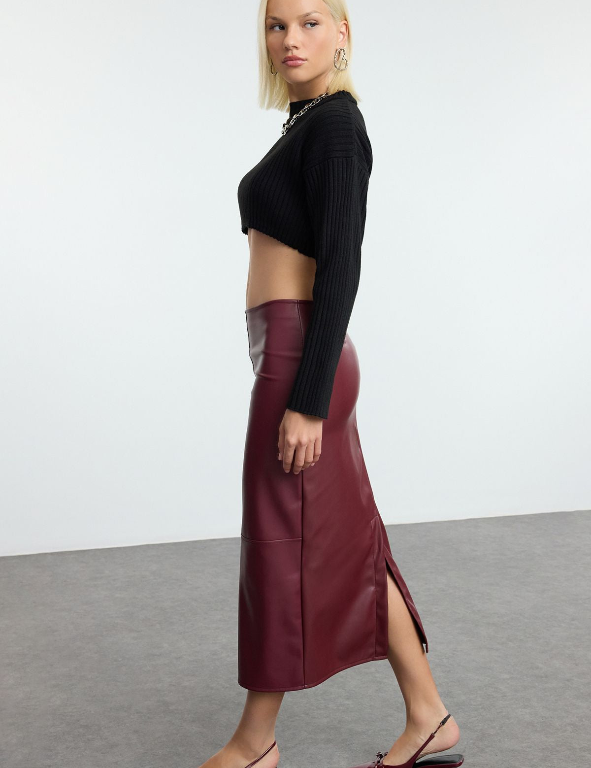 Discover our Faux Leather Burgundy Midi Skirt – the perfect blend of sophistication and style. This high-waisted, sleek skirt is ideal for both office and evening looks, making it a must-have for every fashion-forward woman.