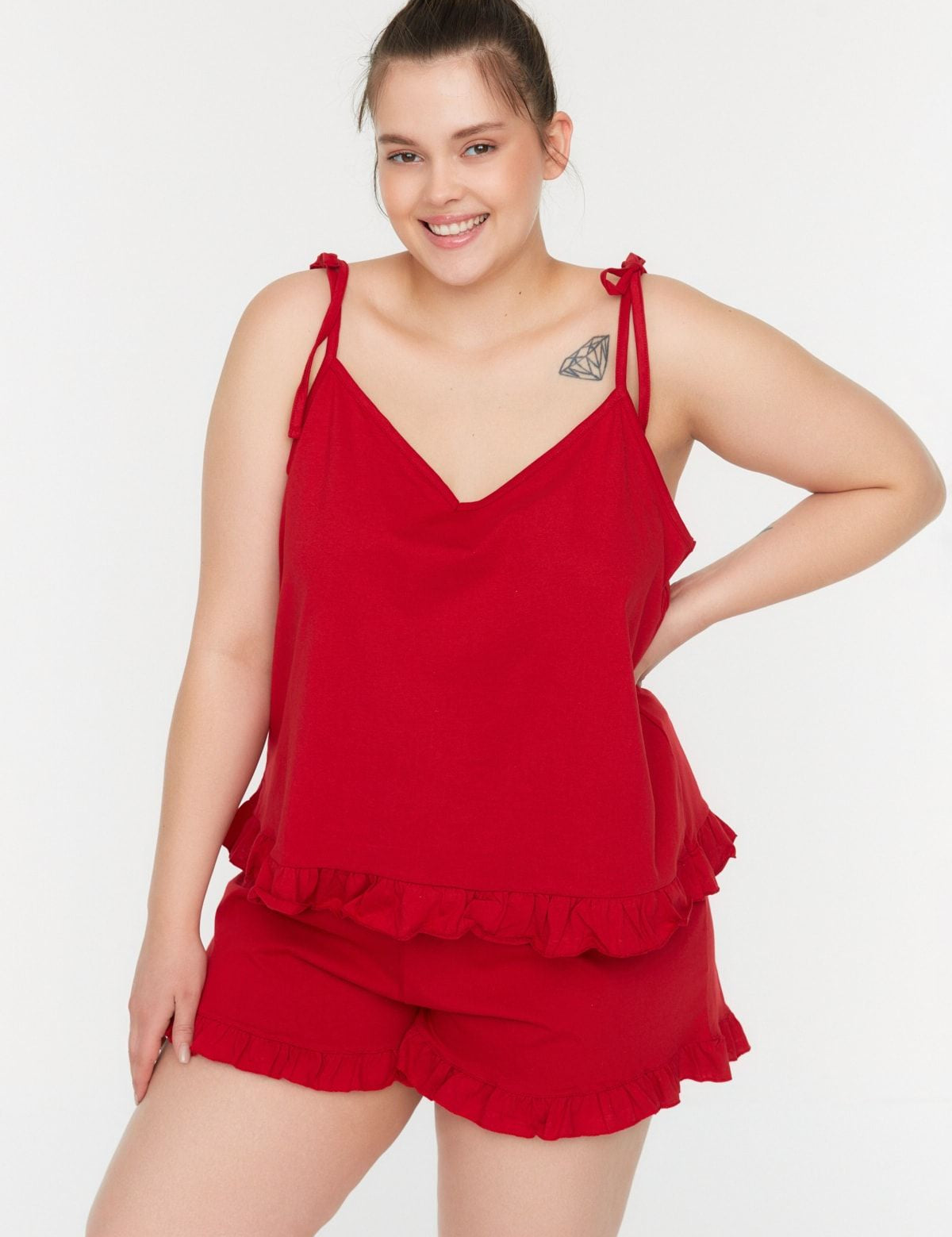 Get cozy with our Women’s Red Ruffled Pajama Set. Featuring a sleeveless came top with adjustable straps and matching shorts, this plus-size sleepwear is designed for comfort and style with playful ruffle details.