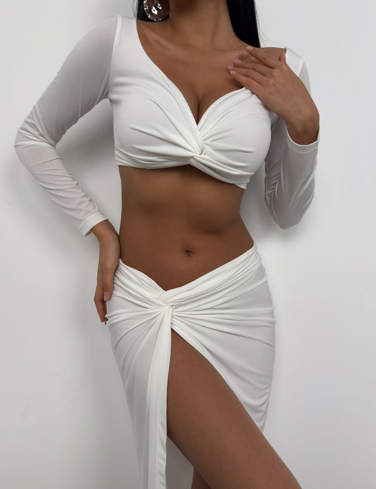 Shop our Elegant White Long-Sleeve Twist-Front Crop Top for a chic and sophisticated look. Featuring a twist-front design and long sleeves, this versatile crop top is perfect for both casual and formal occasions enjoy free shipping!