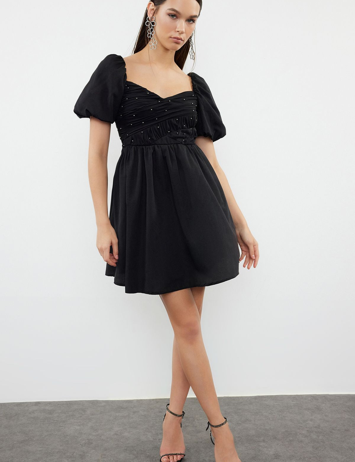 
Shop our Chic Black Puff Sleeve Mini Dress for an elegant and stylish look. Perfect for cocktail parties and special occasions, this dress features a ruched bodice with beaded details and voluminous puff sleeves. Buy now and shine at your next event enjoy free shipping!