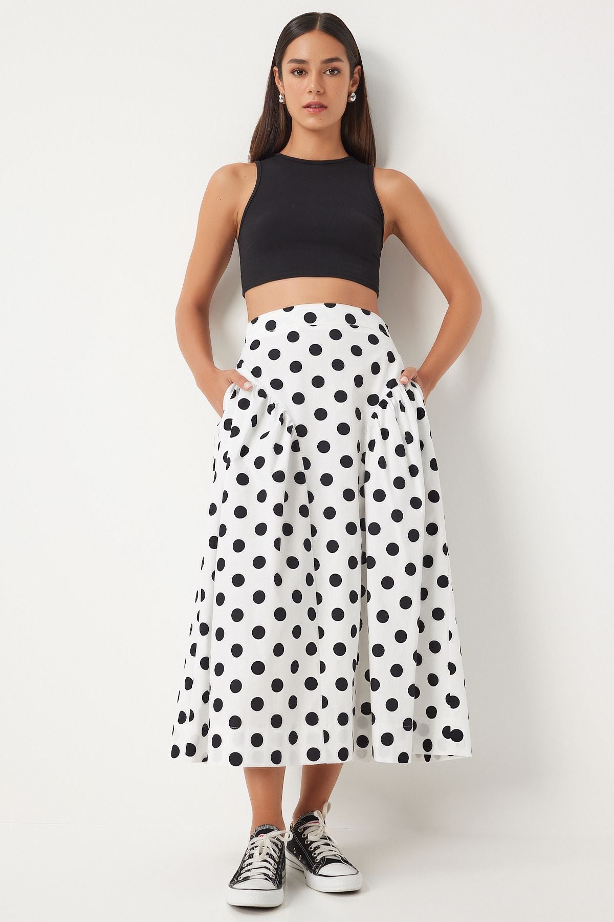 Shop our chic polka dot high-waisted midi skirt, featuring a classic black and white pattern, flattering A-line silhouette, and convenient pockets. Perfect for casual outings or stylish get-togethers. Explore versatile women’s fashion now!