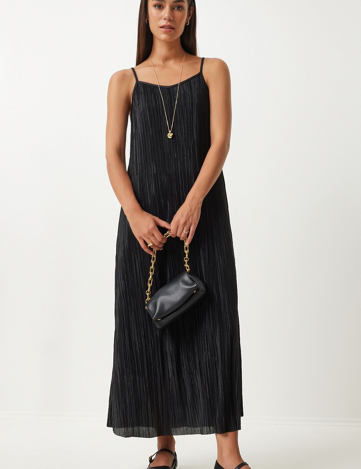 Step out in timeless elegance with our Black Pleated Maxi Dress. Featuring delicate spaghetti straps and a flattering A-line silhouette, this versatile dress is perfect for casual outings, evening events, and special occasions. Shop now at atikastyle 

	•	Black pleated maxi dress
	•	Women’s elegant dress
	•	Spaghetti strap dress
	•	A-line silhouette dress
	•	Versatile black dress
	•	Lightweight maxi dress
	•	Stylish evening wear
	•	Chic casual dress
	•	Sophisticated women’s dress
	•	Br