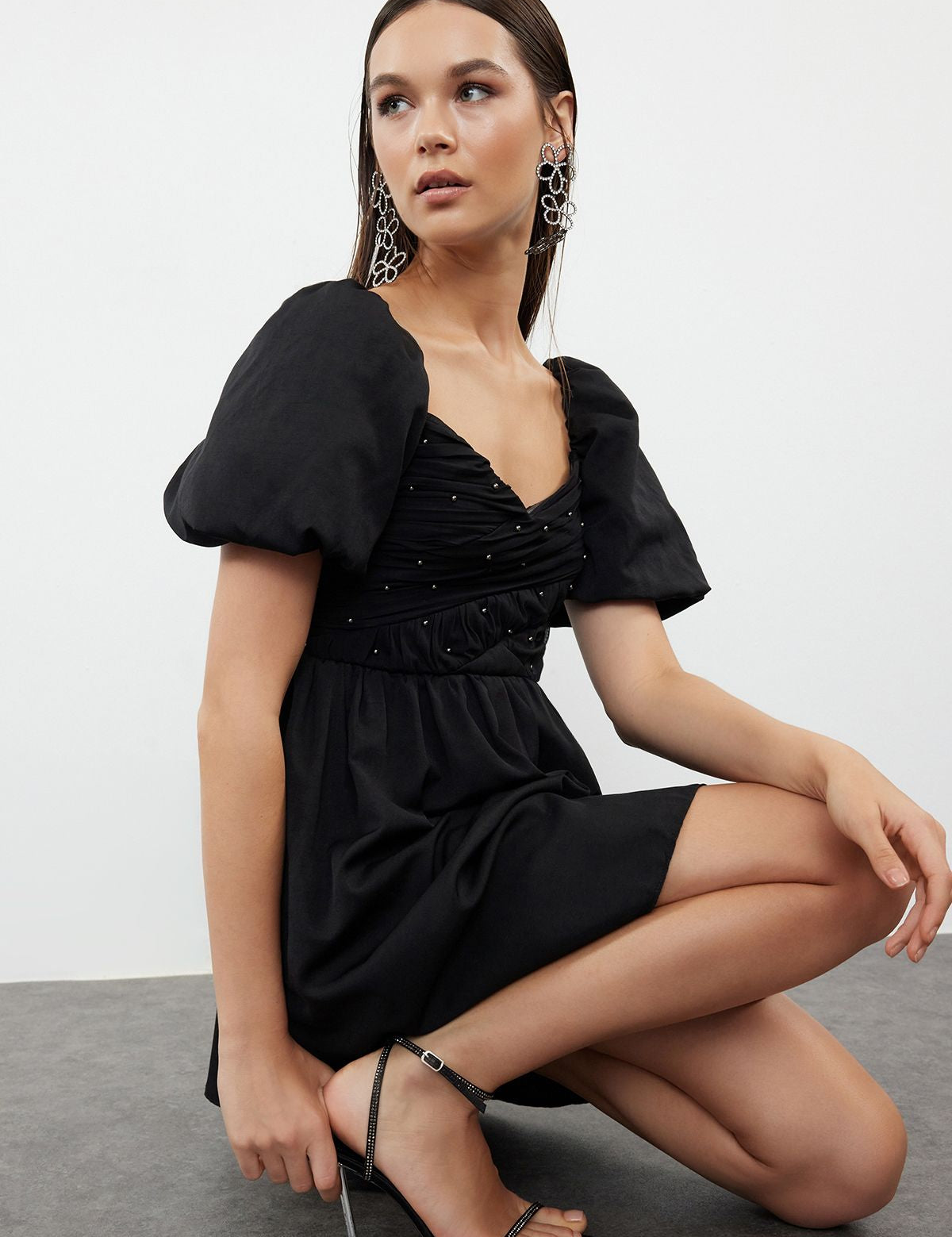 Elevate your style with our Chic Black Puff Sleeve Mini Dress. Featuring a sweetheart neckline, ruched bodice with beaded details, and voluminous puff sleeves, this elegant dress is perfect for any special occasion. Shop now for a sophisticated look!