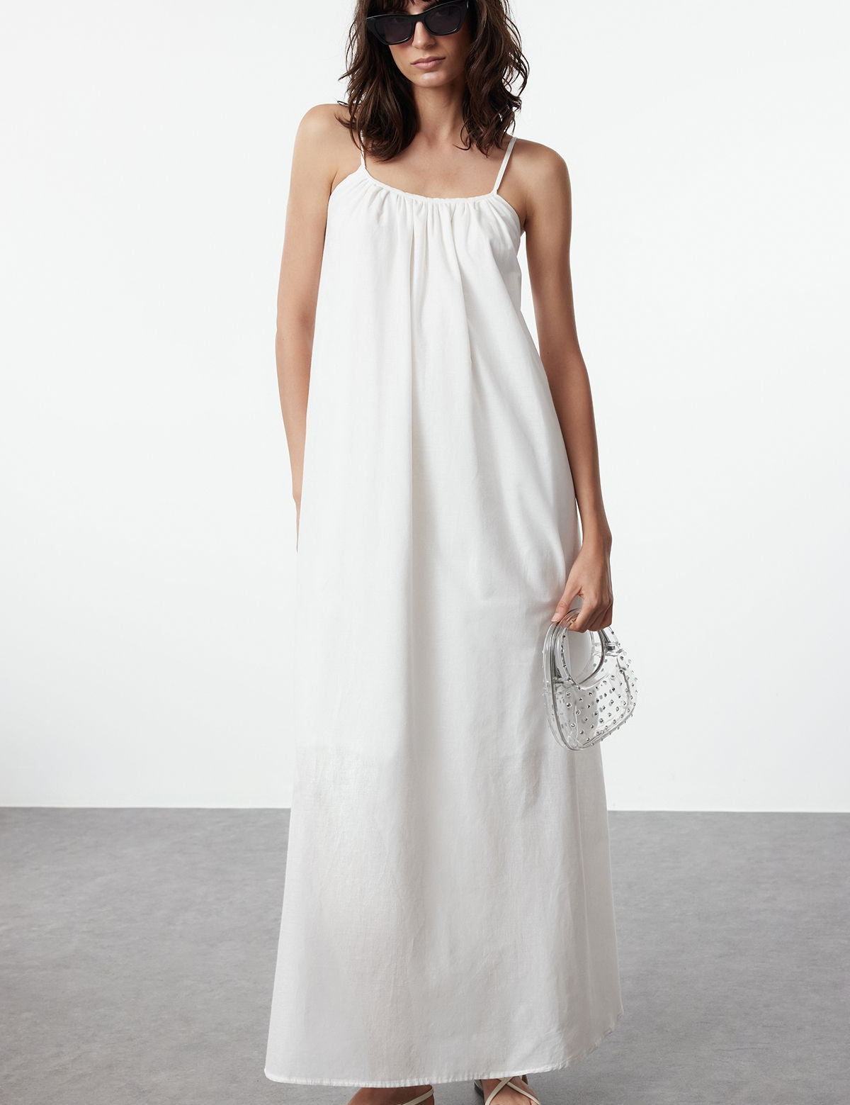 white maxi sundress, effortless summer dress, women’s beach dress, lightweight white sundress, relaxed silhouette dress, spaghetti strap sundress, breathable summer dress, elegant white maxi dress, comfortable beach outfit, flowing white sundress