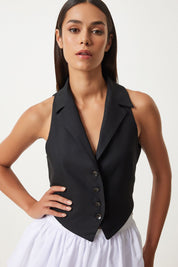 
Black button-down vest, classic black vest, tailored black vest, women’s stylish vest, V-neck vest with lapels, versatile black vest, formal black vest, casual black vest, sophisticated women’s vest, black vest for layering.
