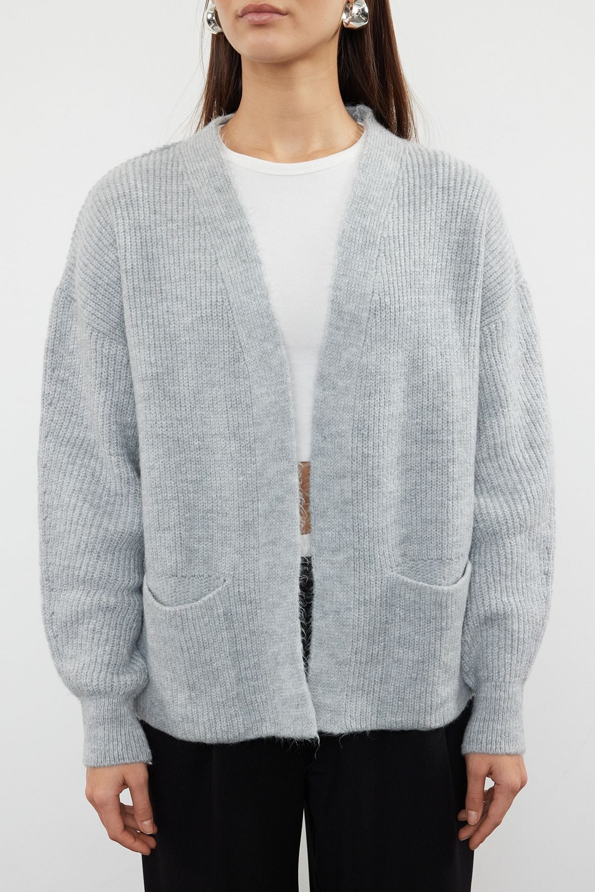  Stay cozy and stylish with our Light Gray Open-Front Cardigan. Featuring a relaxed fit, ribbed texture, and front pockets, this soft wool blend cardigan is perfect for layering over your favorite outfits. Shop now for versatile and chic knitwear!