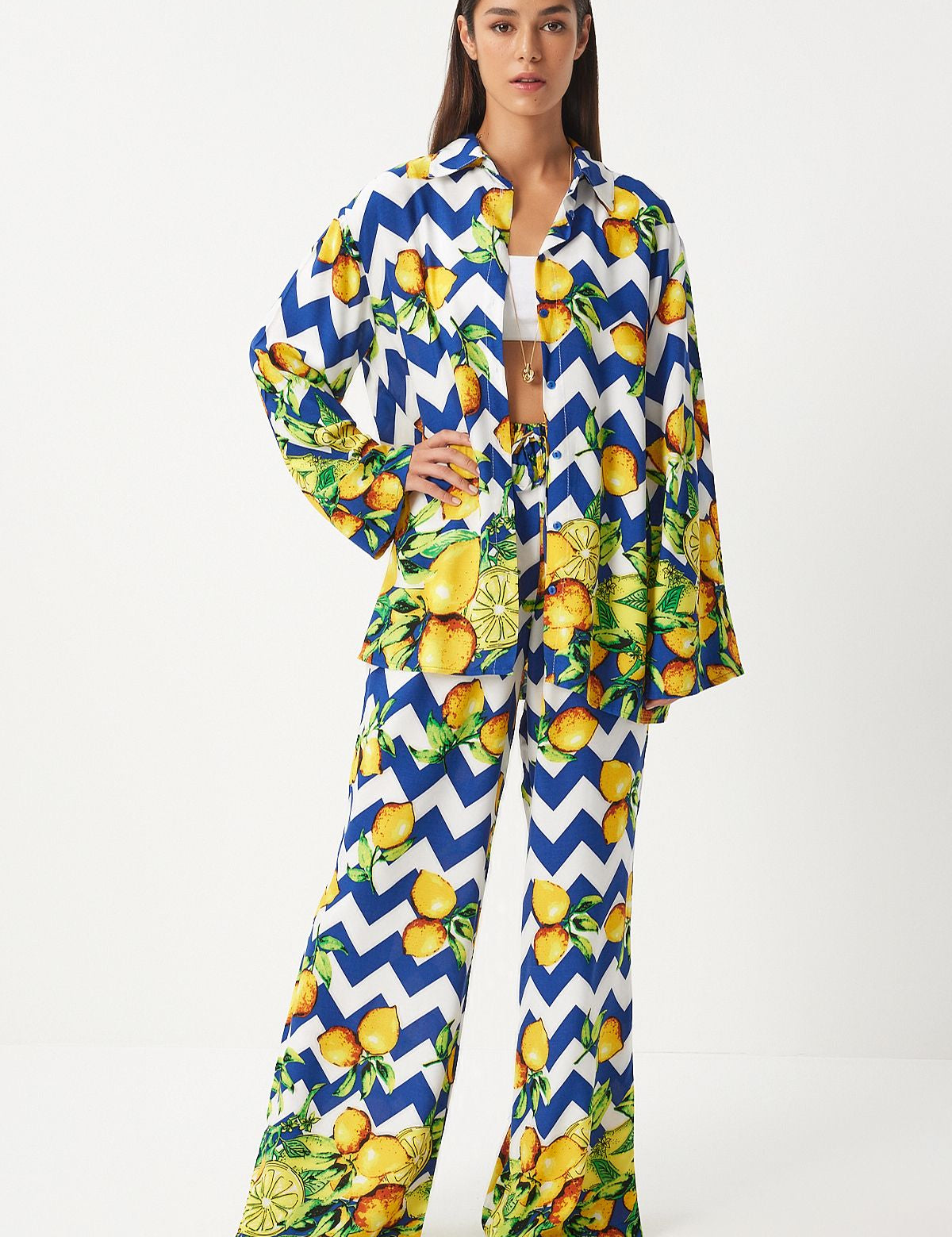  Make a bold statement with our Lemon Print Two-Piece Set. Featuring a playful lemon print on a striking chevron pattern, this vibrant and comfortable set is perfect for casual outings and summer parties. Shop now for stylish and fun fashion!
