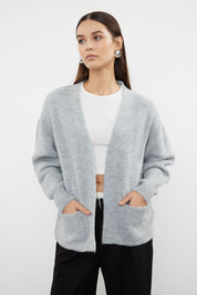  Stay cozy and stylish with our Light Gray Open-Front Cardigan. Featuring a relaxed fit, ribbed texture, and front pockets, this soft wool blend cardigan is perfect for layering over your favorite outfits. Shop now for versatile and chic knitwear!