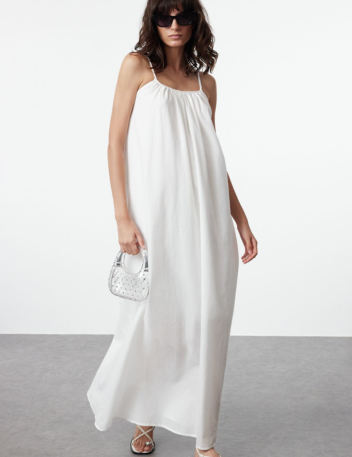 Shop our Effortless White Maxi Sundress, featuring a relaxed, flowing silhouette and delicate spaghetti straps. Perfect for warm days and beach outings, this lightweight dress keeps you cool and stylish all day long enjoy free shipping!.
